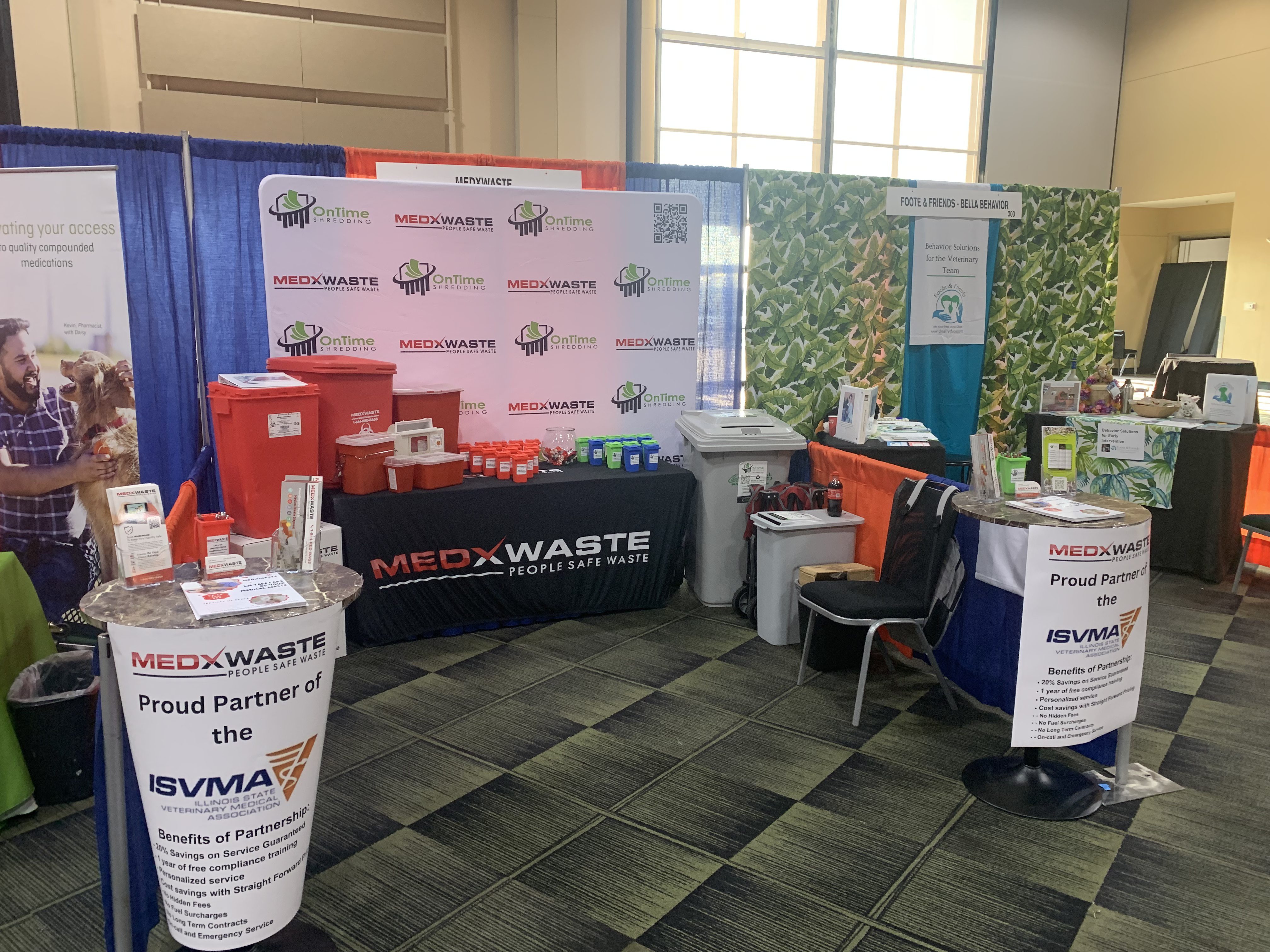 MedXWaste trade show booth with biohazard containers and OnTime Shredding backdrop