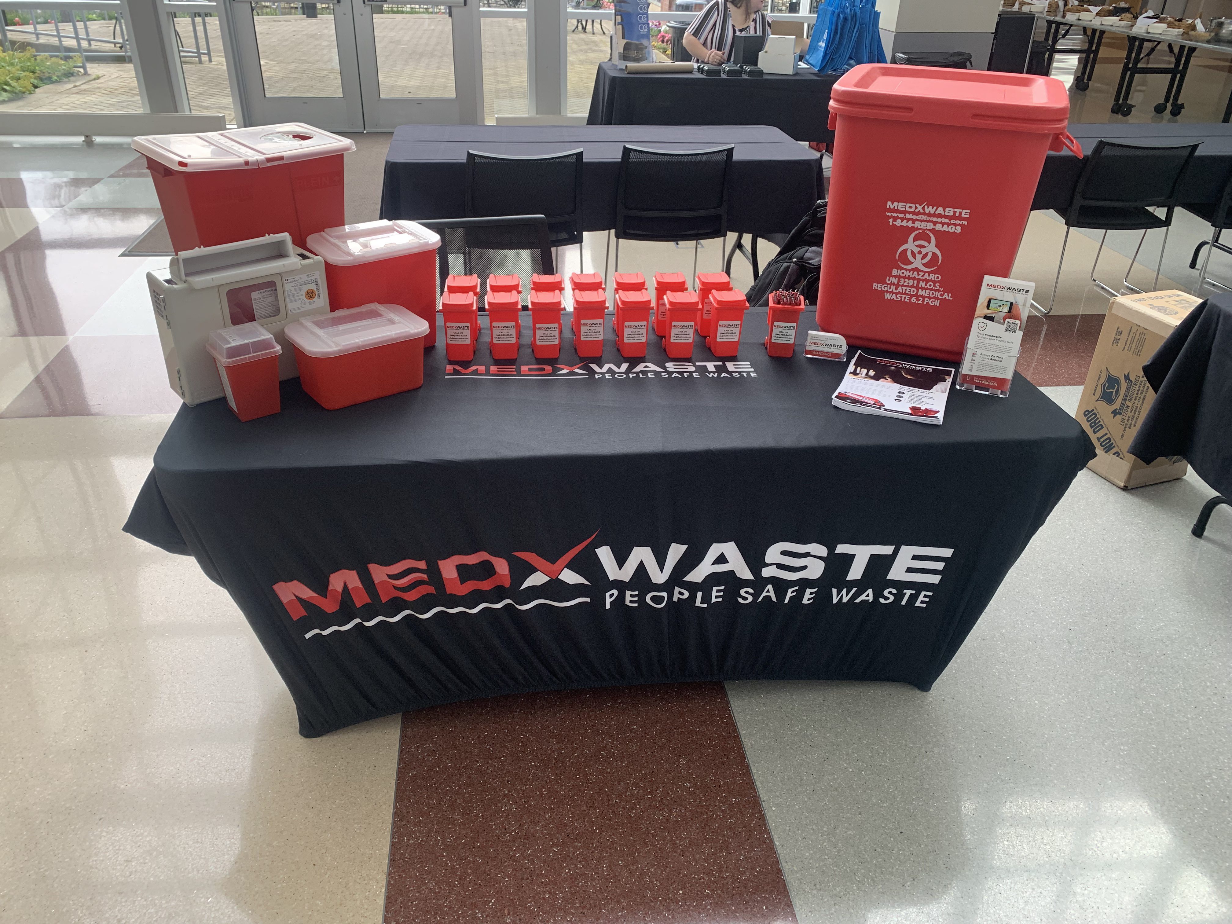 MedXWaste branded vehicle and service representative at medical waste pickup location